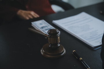 Justice and law concept.Male judge in a courtroom with the gavel, working with, computer and...