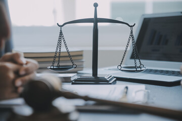 Justice and law concept.Male judge in a courtroom with the gavel, working with, computer and...