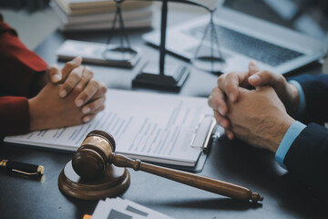 Justice and law concept.Male judge in a courtroom with the gavel, working with, computer and...