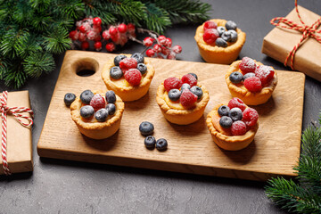 Naklejka na ściany i meble Christmas cupcakes adorned with berries