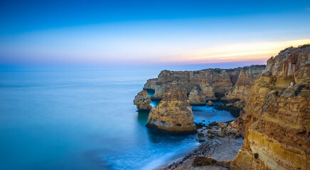 Limestone cliffs at Praia Da Marinha beach at dusk in the Algarve region of southern Portugal