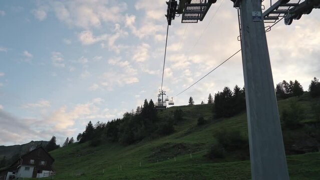Chairlift or cable car riding over Stoos village and mountain landscape at Schwyz, Switzerland