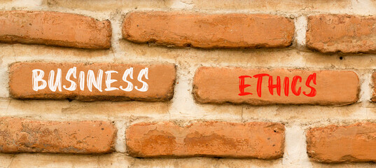 Business ethics symbol. Concept words Business ethics on beautiful brown brick wall. Beautiful...
