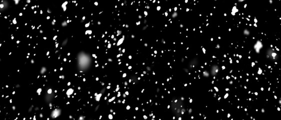 Falling snowflakes out of focus on black background for overlay blending mode. Snowing, snowfall,...