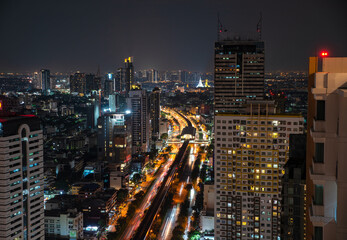 Obraz premium Aerial City view of Bangkok city and subway station Thailand Bangkok skyline and skyscraper with light trails on Sathorn Road center of business in Bangkok downtown. Bangkok Thailand