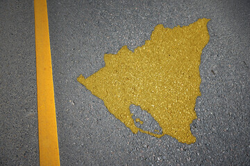 yellow map of nicaragua country on asphalt road near yellow line.