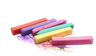 Colorful chalks pile with scribbles isolated on white, side view