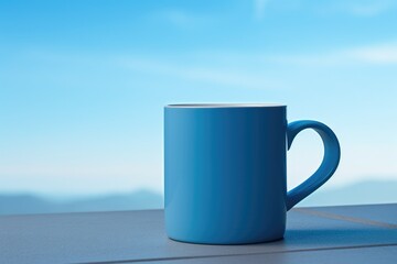 A blue coffee cup sitting on top of a table. Perfect for coffee shop promotions or home decor...