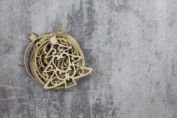 Toy in the shape of a Christmas tree lies on a set of round wooden toys for the New Year