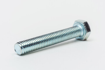 iron bolt on a white background. metal bolt on a light background. photos of a threaded bolt for the catalog