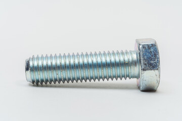 iron bolt on a white background. metal bolt on a light background. photos of a threaded bolt for...