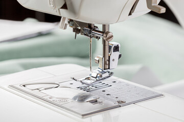 Sewing machine, stitching fabrics, needle in a round plan