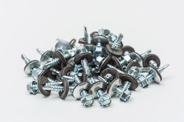 roofing screws on a white background. photo of self-tapping screws for the catalog on a light...
