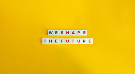 We Shape The Future Phrase on Block Letter Tiles on Yellow Background. Minimal Aesthetics.