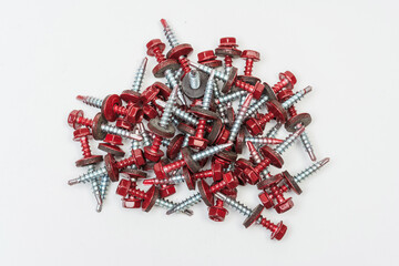 roofing screws on a white background. photo of self-tapping screws for the catalog on a light background. set of bolts for working with metal tiles and iron
