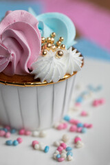 Cupcake blue and pink for gender party. boy or girl. delicious cupcakes with blue and pink cream, golden sparkles celebration concept when the gender of the child becomes known. Festive baby shower 