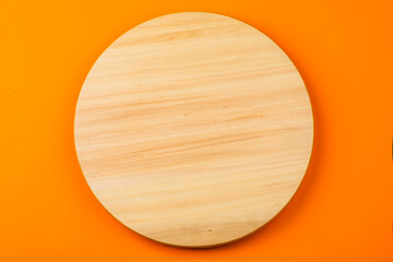Wooden round board on the table