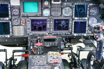 Interior view of helicopter Agusta cockpit with control pedals, dashboard, displays, selected focus