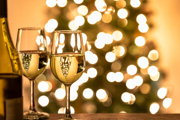 two glass of wine in front of the christmas tree