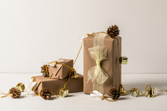 Holiday Gifts wrapped in Kraft paper on white background