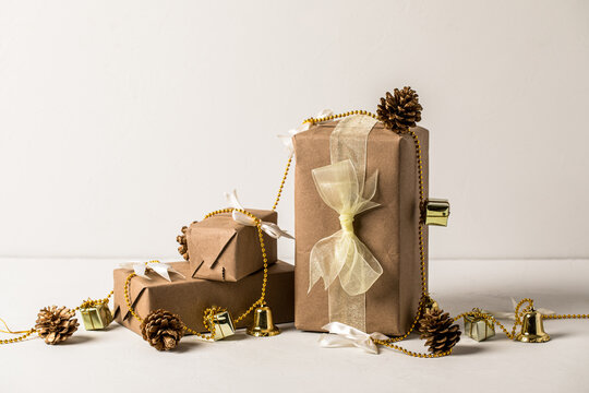 Holiday Gifts wrapped in Kraft paper on white background