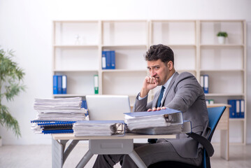 Young male employee working in the office