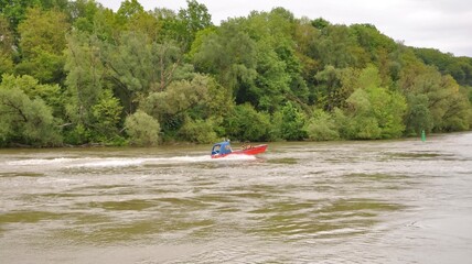 Fototapeta na wymiar Speedboat to rescue people in a ride on Danube river near Passau city. Bavaria, Germany