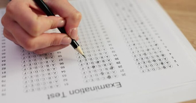 Educational test and university student holds pencil for testing exams and writes an answer sheet