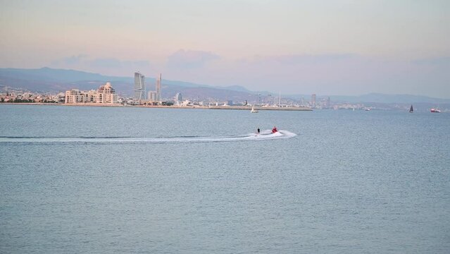 The water skiing on the sea behind a motorboat at sea bay
