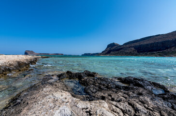 Fototapeta na wymiar Panorama of the sea and the rock during a windy day at Blue lagoon in Balos, Crete, Greece. Beautiful lagoon at Mediterranean Sea. Shot taken near Gramvousa Island.