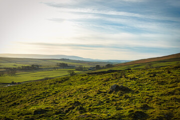 Beautiful landscape photo of the blue sky and nature at Sycamore Gap, UK