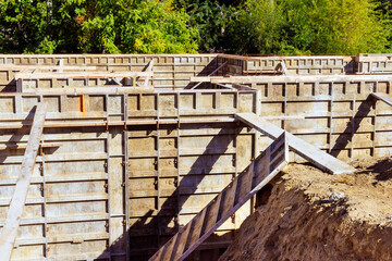 Fototapeta na wymiar Metal formwork has been assembled for pouring concrete to building house foundation
