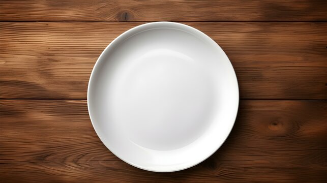 Top View of an empty Plate in white Colors on a wooden Table. Elegant Template with Copy Space