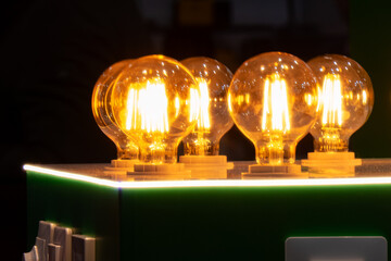 Round energy efficient light bulbs in a glass bulb with warm light.