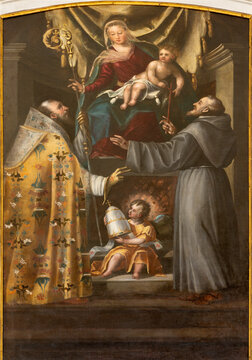 VICENZA, ITALY - NOVEMBER 5, 2023: The  baroque painting of Madonna with the sanits n the church Chiesa di San Gaetano by unknown artist.