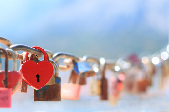 Old red heart shaped lock. Love lock on the bridge.  Red love padlock. Valentines day, unity, memory concepts.