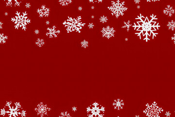 White snowflakes on a red background. Seamless pattern.