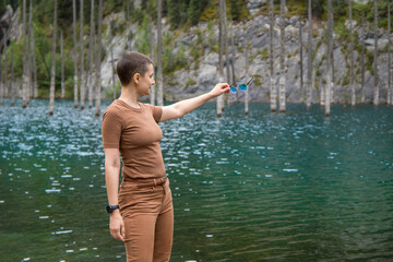 Woman touring on Kolsai gorge with Kaindy lake. Picturesque nature of Kazakhstan in Almaty region.