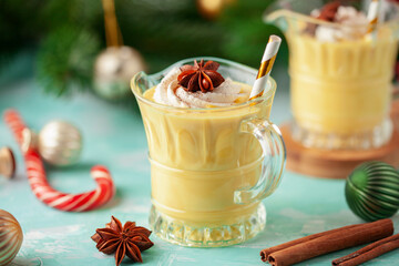 Christmas Bombardino cocktail with egg liqueur and rum. Wooden color background with christmas...