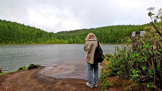 Woman watching the lake 'Lagoa do Can&aacute;rio' in Furnas, Azores, close to sete cidades