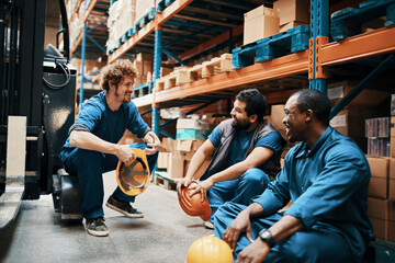 Group of men sitting in warehouse