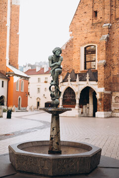 Krakow, Poland - September 20, 2023. Bronze statue of a student known as Zak on the fountain in Krakow, Poland. Monument is located at St. Mary Square in Krakow, listen by UNESCO organization