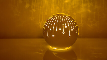 a christmas decoration in the form of an illuminated ball with shooting stars reflected on the wall in the warm light 