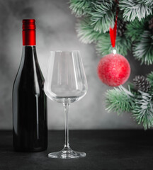 Christmas card. Wine bottle with glass Christmas tree with red ball
