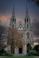Fototapeta na wymiar Paris, France - 11 18 2023: Saint Clotilde Basilica. View the facade of the Basilica from the park.