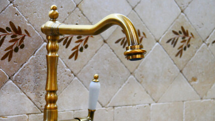 Close-up of a golden luxury faucet