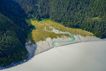 Aerial view of a melt water curvy river delta flowing into the Taku River east of Juneau, Alaska