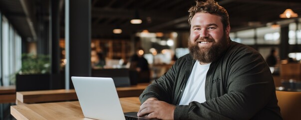 Portrait of smiling plus size man near the laptop in the office. Generative ai