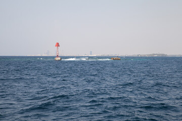 Red beacon tower is marking the border of a fairway to Jeddah Islamic Seaport