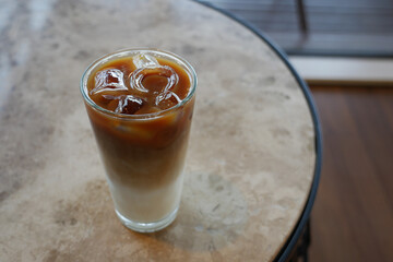 iced late in a transparent glass on cafe table outdoor 